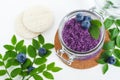 Homemade blueberry face and body sugar scrub/bath salts/foot soak in a glass jar. DIY cosmetics for natural skin care.