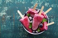 Homemade blueberry ice cream or popsicles decorated green mint leaves on teal rustic table, frozen fruit juice Royalty Free Stock Photo