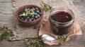Blueberry jam in jar with berries and leaves over rustic wooden table Royalty Free Stock Photo