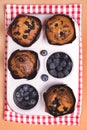 Homemade Blueberry Muffins with Berries Baking Dish Napkin Light Brown Background Top View Vertical Royalty Free Stock Photo