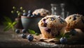 Homemade blueberry muffins with fresh berries on rustic wooden background