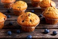 Homemade Blueberry Muffins with fresh berries on wooden table. Royalty Free Stock Photo