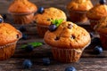 Homemade Blueberry Muffins with fresh berries on wooden table. Royalty Free Stock Photo