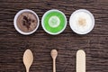 Homemade body scrubs on wood background.