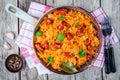 Homemade braised sauerkraut with smoked sausages in a frying pan