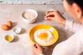 Homemade bread baking. closeup woman hands adding salt in flour, dough preparation in bright kitchen with marble countertop Royalty Free Stock Photo