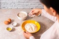 Homemade bread baking. closeup woman hands mixing ingredients for dough preparation in bright kitchen with marble countertop Royalty Free Stock Photo