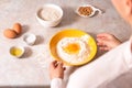 Homemade bread baking. closeup woman hands mixing ingredients for dough preparation in bright kitchen with marble countertop Royalty Free Stock Photo