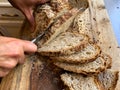 Homemade Bread being Sliced on a Wooden Cutting Board During Covid19 Royalty Free Stock Photo