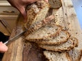 Homemade Bread being Sliced on a Wooden Cutting Board During Covid19 Royalty Free Stock Photo