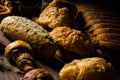 Homemade bread consists of slice and bun, French bread, muffins and croissants, placed on brown wood table, for use as posters and Royalty Free Stock Photo