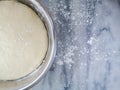 Homemade bread dough fermenting in aluminum pot