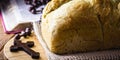 Homemade bread made in the Easter and Eucharist period, called Christ bread, religious symbol, with Bible and crucifix in the