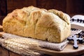 Homemade bread made in the Easter and Eucharist period, called Christ bread, religious symbol, with Bible and crucifix in the