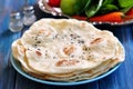 Homemade bread pita bread on a blue background.