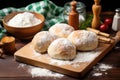 homemade bread rolls with a kneading board and rolling pin