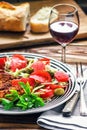 Homemade Breaded German Weiner Schnitzel and fresh vegetable spring salad with tomato, green olives, cabbage and parsley Royalty Free Stock Photo