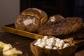 Homemade breads and assorted cheeses exposed on the wooden table Royalty Free Stock Photo