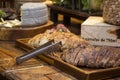 Homemade breads and assorted cheeses exposed on the wooden table Royalty Free Stock Photo