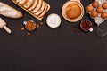 Homemade breads or bun, croissant and bakery ingredients, flour, almond nuts, hazelnuts, eggs on dark background, Bakery backgroun Royalty Free Stock Photo