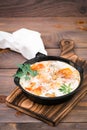 Homemade breakfast of shakshuka fried eggs with tomatoes and herbs in a pan on Royalty Free Stock Photo