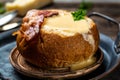 Homemade Broccoli and Cheddar Soup in a Bread Bowl. cheese cream soup served with spoon. Food recipe background. Close up