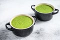 Homemade broccoli and spinach cream soup in bowl. White background. Top view Royalty Free Stock Photo