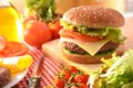 Homemade burger on cutting board with ingredients in kitchen Royalty Free Stock Photo