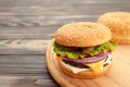 Homemade burger ingredients arranged on brown wooden background Royalty Free Stock Photo