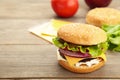 Homemade burger ingredients arranged on grey wooden background Royalty Free Stock Photo