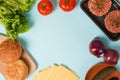 Homemade burger ingredients on blue table background with copy space Royalty Free Stock Photo