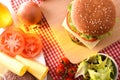 Homemade burger with ingredients on checkered tablecloth top Royalty Free Stock Photo