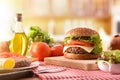 Homemade burger with ingredients on table in front Royalty Free Stock Photo