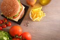 Homemade burger with vegetables and chips on table top Royalty Free Stock Photo