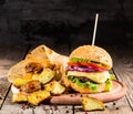 Homemade burgers with beef and fried potatoes