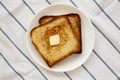 Homemade Buttered Toast on a white plate, top view