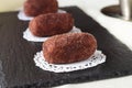 Homemade cake without baking named potato on a black tile. Selective focus. Royalty Free Stock Photo