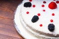 homemade cake, blackberries red currants raspberries on a wooden table. rustic Royalty Free Stock Photo