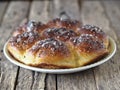 Homemade cake.Buns filled with jam, sprinkled with sesame seeds and icing sugar on a porcelain plate on an ancient wooden table Royalty Free Stock Photo