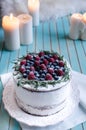 Homemade cake decorated berries on plate over wooden turquoise background Royalty Free Stock Photo