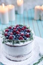 Homemade cake decorated berries on plate over wooden turquoise background Royalty Free Stock Photo