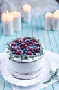 Homemade cake decorated berries on plate over wooden turquoise background Royalty Free Stock Photo