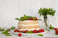 Homemade cake decorated strawberry and mint on white background
