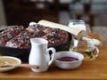 Homemade cake.Jam filled buns sprinkled with sesame and icing sugar in a baking pan on a kitchen cutting Board with ingredients Royalty Free Stock Photo