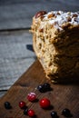 Homemade cake with nuts and fruits on dark wood background, recipe. .