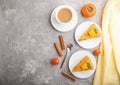 Homemade cake with persimmon and pumpkin and a cup of coffee on a gray concrete background. top view, copy space Royalty Free Stock Photo