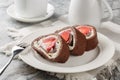 Homemade cake roll with strawberry and cream cheese closeup. Horizontal Royalty Free Stock Photo