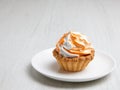 Homemade cake on a white plate stands on a wooden table Royalty Free Stock Photo