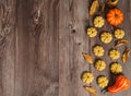 Orange decorative and delicious pumpkin cookies on wooden background. Royalty Free Stock Photo