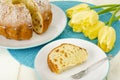 Homemade cakes, yellow tulips on white wooden table